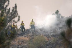 Firefighters douse hot spots from the Trinity Ridge Fire near Featherville, Idaho on Aug. 25.