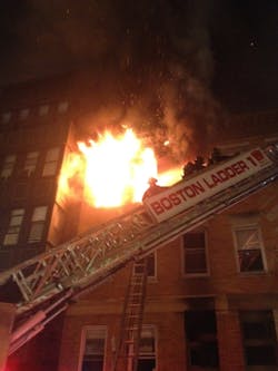 Boston firefighters battle a four-alarm blaze at an apartment building on Sept. 4 that left a woman severely burned. Boston firefighters battle a four-alarm blaze at an apartment building on Sept. 4 that left a woman severely burned.