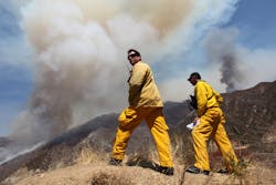 Los Angeles County Firefighters Mitch Brookhyser, left, and Denis Cross survey the Williams Fire burning in the San Gabriel Mountains in the Angeles National Forest near Glendora, Calif. on Sept. 4.