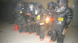 Responders prepare to enter a room and use devices that detect for the presence of chemical, biological, and radiological material during the revised 40-hour class in Anniston, AL.