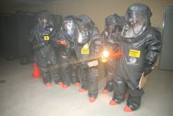 Responders prepare to enter a room and use devices that detect for the presence of chemical, biological, and radiological material during the revised 40-hour class in Anniston, AL. Responders prepare to enter a room and use devices that detect for the presence of chemical, biological, and radiological material during the revised 40-hour class in Anniston, AL.