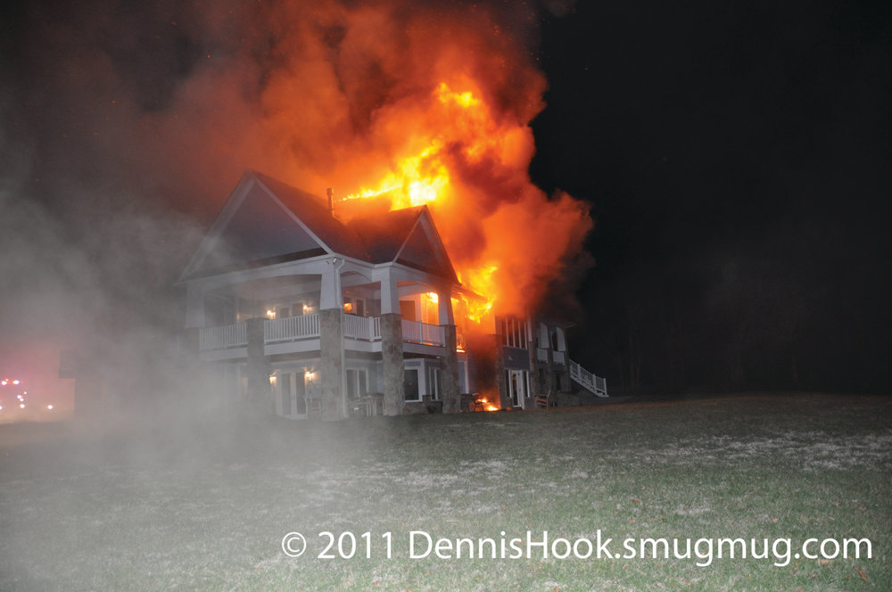 Photo 1. As firefighters began an emergency evacuation of the home, Huntingtown Command reported seeing a flash of light across the large window in the second-floor open foyer concurrent with a rapid increase in fire and smoke issuing from the second floor.