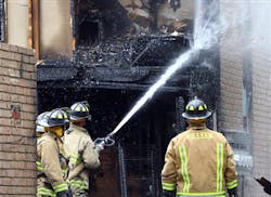 Firefighters knock down hot spots at the scene of a fatal apartment fire at the Casa Tejas Apartments in Killeen, Texas on Sept. 14.
