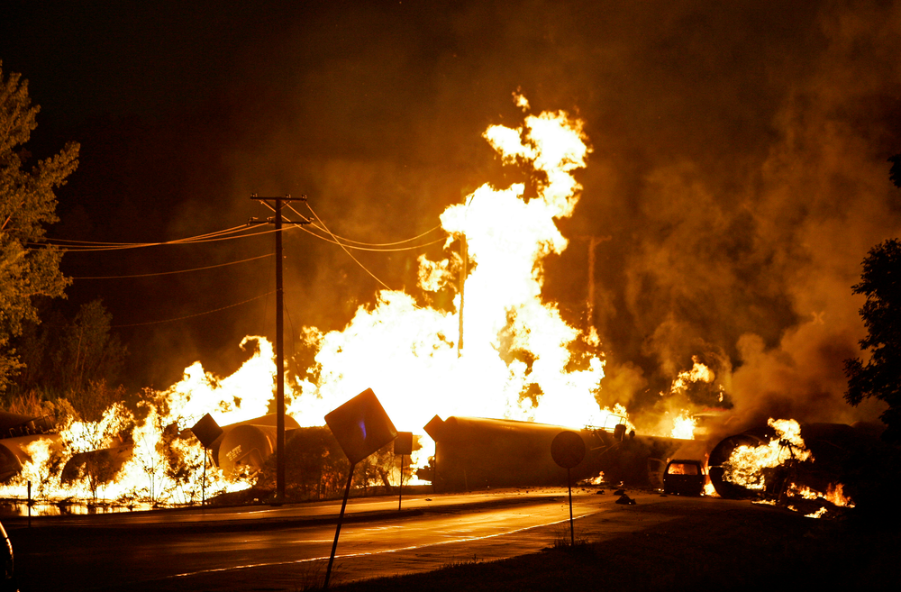 A car at is seen engulfed in flames from rail cars loaded with ethanol that derailed in Rockford, Ill. on June 19, 2009.