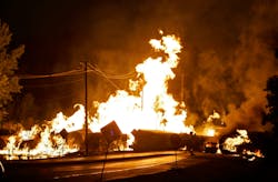 A car at is seen engulfed in flames from rail cars loaded with ethanol that derailed in Rockford, Ill. on June 19, 2009.