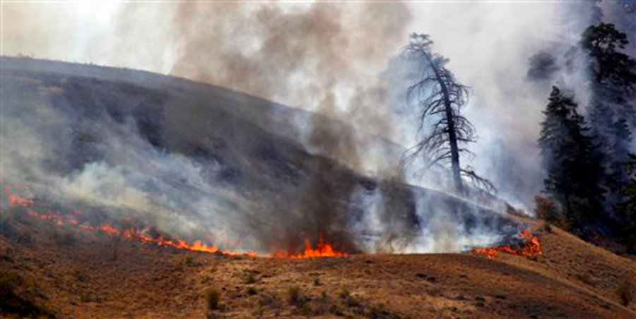Flames burn at one end of a wildfire on Sept. 10 near Wenatchee, Wash.