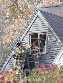 Firefighters battled a three-alarm blaze that tore through a home in Bedford, N.H. on Oct. 23.
