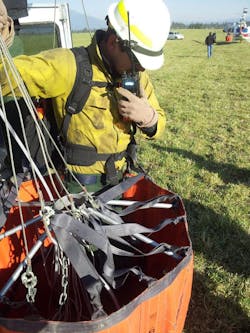 A wildland firefighting pilot carried a firefighter close to a half-mile to safety in a water bucket after the Pole Creek Fire flared up on Sept. 28, closing off evacuation routes. A wildland firefighting pilot carried a firefighter close to a half-mile to safety in a water bucket after the Pole Creek Fire flared up on Sept. 28, closing off evacuation routes.