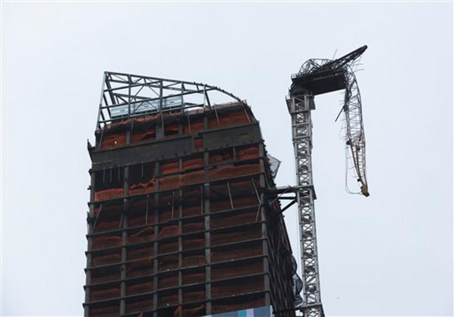 A construction crane atop a luxury high-rise dangles precariously over the streets after collapsing in high winds from Hurricane Sandy on Oct. 29.