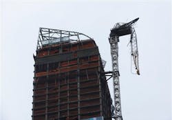 A construction crane atop a luxury high-rise dangles precariously over the streets after collapsing in high winds from Hurricane Sandy on Oct. 29.
