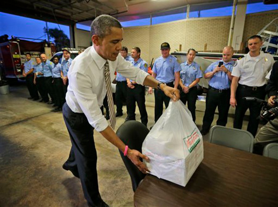 President Barack Obama delivers boxes of Krispy Kreme doughnuts to firefighters at Fire Station No. 14., during an unannounced visit on Oct. 25 in Tampa, Fla.