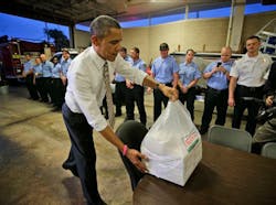 President Barack Obama delivers boxes of Krispy Kreme doughnuts to firefighters at Fire Station No. 14., during an unannounced visit on Oct. 25 in Tampa, Fla.