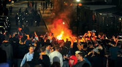A crowd gathers around a fire set on Grant Avenue after the WVU football team’s 48-45 victory over the University of Texas on Oct. 7 in Morgantown, W.Va. A crowd gathers around a fire set on Grant Avenue after the WVU football team’s 48-45 victory over the University of Texas on Oct. 7 in Morgantown, W.Va.
