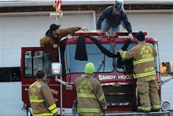 Sandy Hook firefighters hang bunting on their firetruck in the Sandy Hook village of Newtown, Conn. following the school shooting.