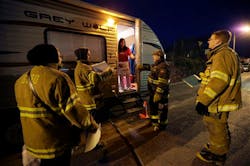 Gerritsen Beach Volunteer Fire Department representatives check on local resident Debbie Krieger, who has been living in a trailer while her Superstorm Sandy-damaged house is being rebuilt, on an bitter cold night when temperatures were expected to dip into the single digits in New York, Thursday, Jan. 24, 2013. Visiting firefighter Mike Smith, of the Richmond, Mass., Fire Department, second from right joined the group. The firefighters had donated blankets and space heaters available for those who needed them. Gerritsen Beach Volunteer Fire Department representatives check on local resident Debbie Krieger, who has been living in a trailer while her Superstorm Sandy-damaged house is being rebuilt, on an bitter cold night when temperatures were expected to dip into the single digits in New York, Thursday, Jan. 24, 2013. Visiting firefighter Mike Smith, of the Richmond, Mass., Fire Department, second from right joined the group. The firefighters had donated blankets and space heaters available for those who needed them.