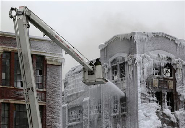 Firefighters continue battling a massive warehouse fire Wednesday, Jan. 23, 2013 in Chicago, that officials say is one of the largest fires in recent years. More than 170 firefighters have responded to the five-alarm blaze that started at about 9 p.m. Tuesday Jan, 22, 2013.