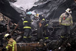 Investigators look over the aftermath of a fire at the Melrose Shopping Center Friday, Jan. 25, 2013, in Cheltenham, Pa. The fire at a shopping center in suburban Philadelphia has damaged nearly a half dozen stores and left one person dead. Officials say police pulled one person from the blaze and that the victim later died at a hospital. Two firefighters also suffered minor injuries. (AP Photo/Matt Rourke) Investigators look over the aftermath of a fire at the Melrose Shopping Center Friday, Jan. 25, 2013, in Cheltenham, Pa. The fire at a shopping center in suburban Philadelphia has damaged nearly a half dozen stores and left one person dead. Officials say police pulled one person from the blaze and that the victim later died at a hospital. Two firefighters also suffered minor injuries. (AP Photo/Matt Rourke)