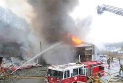 Firefighters battle a fire, Friday Jan. 11, 2013, displacing two businesses and numerous residents in Ashland, Ky.