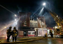 Firefighters work at the scene of a four-alarm fire in a brick business building in Lawrence, Mass. Thursday, Jan. 24, 2013. No injuries were reported according to authorities on the scene. Temperatures dipped into the single digits in the region Thursday.