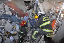Firefighters search for victims in the oil company building. Firefighters search for victims in the oil company building.