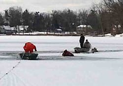 In this photo provided by the Waterford Regional Fire Department, firefighters from Rescue 2 work the scene where two adult men fell through the ice on Scott Lake in Waterford, Mich., on Tuesday, Jan. 1, 2012. One man was hospitalized, and a firefighter sustained a hand injury.