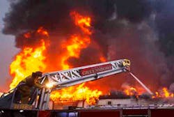 Station 7 firefighter Phil Ruff ducks behind the ladder to shield himself from the intense heat as he works the ladder truck nozzle as firefighters battle a two-alarm blaze at Southeast Church Furniture's warehouse at 808 N. Raleigh St. on Friday, January 11, 2013, in Greensboro, N.C. Station 7 firefighter Phil Ruff ducks behind the ladder to shield himself from the intense heat as he works the ladder truck nozzle as firefighters battle a two-alarm blaze at Southeast Church Furniture's warehouse at 808 N. Raleigh St. on Friday, January 11, 2013, in Greensboro, N.C.