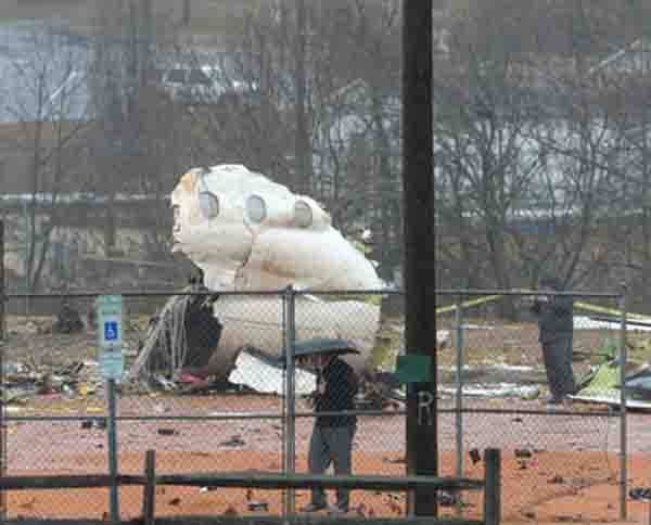 Part of the fuselage of an airplane rests on a softball field where it crashed, in Burlington, N.C., Wednesday, Jan. 16, 2013. Assistant Police Chief Chris Verdeck said that 57-year-old David Gamble of Greensboro died when his plane came down around 6 a.m. Wednesday about 5 miles northeast of the Burlington-Alamance Regional Airport. The plane was a Pilatus PC-12 owned by Labcorp, a medical testing company in Burlington. A spokeswoman with the Federal Aviation Administration says the plane was heading to Morristown, N.J.