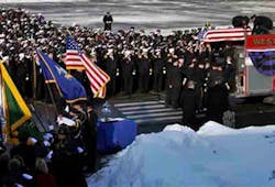 Lt. Mike Chiapperini&apos;s flag covered coffin is placed on a fire truck during a funeral service in Webster, N.Y., Sunday, Dec. 30, 2012. Chiapperini a, volunteer firefighter, was fatally shot as he arrived at a house fire set by the ex-convict who later killed himself.