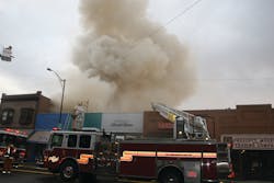 Prescott Fire Department Truck 72 performs roof operations during the early stages of the Whiskey Row fire. Crews were quickly removed from roof operations as command prepared for a defensive operation.
