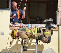 A firefighter participates in the IAFF Fireground Survival hands-on program to learn self-rescue techniques.