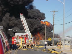 This is a photo I took of firefighters setting up at the scene of a three-alarm tire fire. This is a photo I took of firefighters setting up at the scene of a three-alarm tire fire.