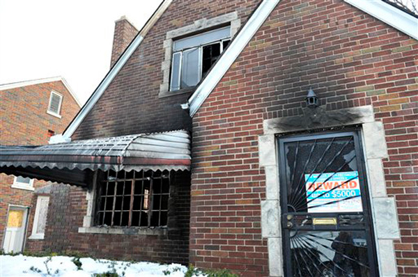 Black marks stain the home at 11742 Kenmoor in Detroit, where nine adults lived, after it was fire bombed early in the morning on Feb. 10, 2013. One person died in the blaze.