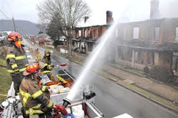 Firefighters use a truck-mounted deck gun to pour thousands of gallons of water per minute on the smoldering remains of the fire on Temple Street in Hinton, W.V. Tuesday, Feb. 26, 2013. Nearly an entire city block in downtown Hinton was razed and residents in 11 homes displaced by the fires. Hinton Police Chief Derek Snavely said Billy Joe Gill, 25, of Hinton, was arrested and charged with first degree arson, a felony. He is believed to be responsible for both incidents. Firefighters use a truck-mounted deck gun to pour thousands of gallons of water per minute on the smoldering remains of the fire on Temple Street in Hinton, W.V. Tuesday, Feb. 26, 2013. Nearly an entire city block in downtown Hinton was razed and residents in 11 homes displaced by the fires. Hinton Police Chief Derek Snavely said Billy Joe Gill, 25, of Hinton, was arrested and charged with first degree arson, a felony. He is believed to be responsible for both incidents.