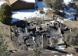 In this aerial photo, law enforcement authorities investigate the charred remains of a cabin Wednesday, Feb. 13, 2013, where quadruple-murder suspect Christopher Dorner is believed to have died after barricading himself inside during a Tuesday stand-off with police in the Angeles Oaks area of Big Bear, Calif. San Bernardino Sheriff&apos;s Deputy Jeremiah MacKay was killed and another wounded during the shootout with Dorner.