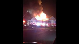 Flames from apartment building lick the night sky.