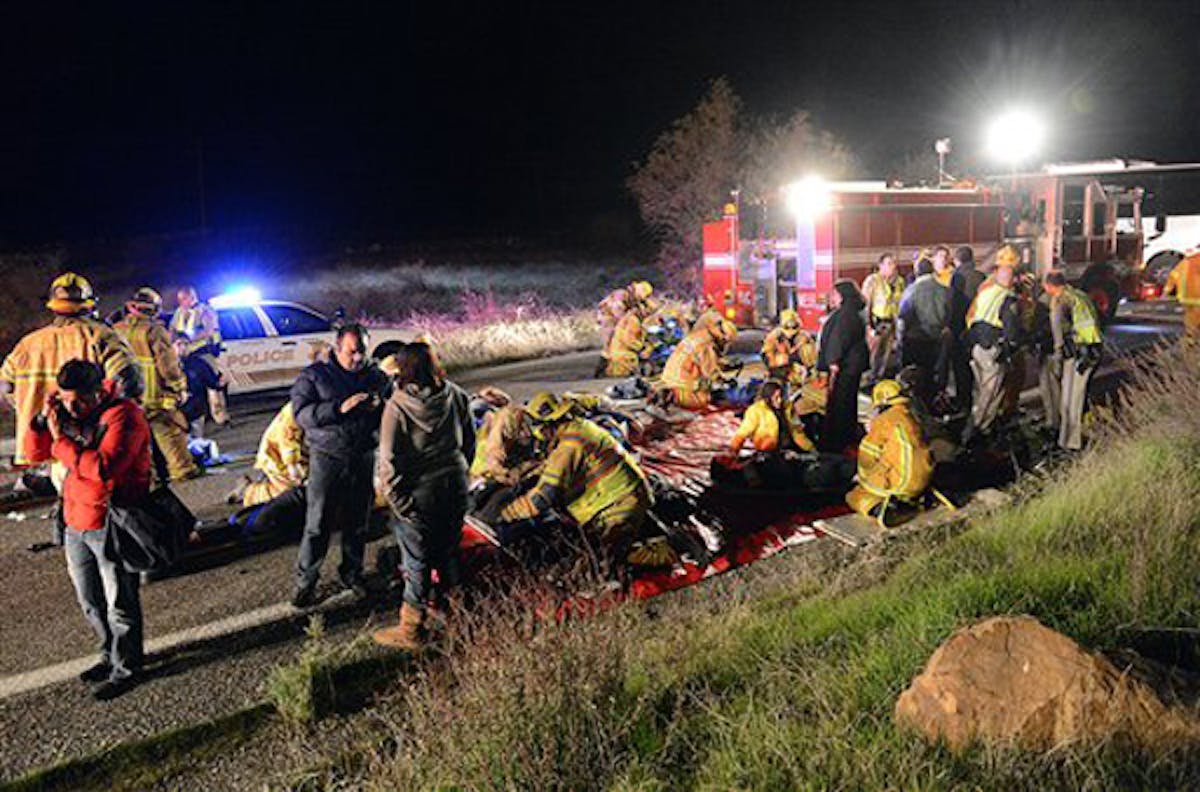 Authorities work the scene where at least eight people were killed and nearly two dozen were injured when a bus carrying a group from Tijuana, Mexico crashed with two other vehicles on its way back from Big Bear Lake on Highway 38 north of Yucaipa, Calif., Sunday, Feb. 3, 2013. Both sides of the highway remained closed two and a half hours after the crash and it was unclear when it would reopen.