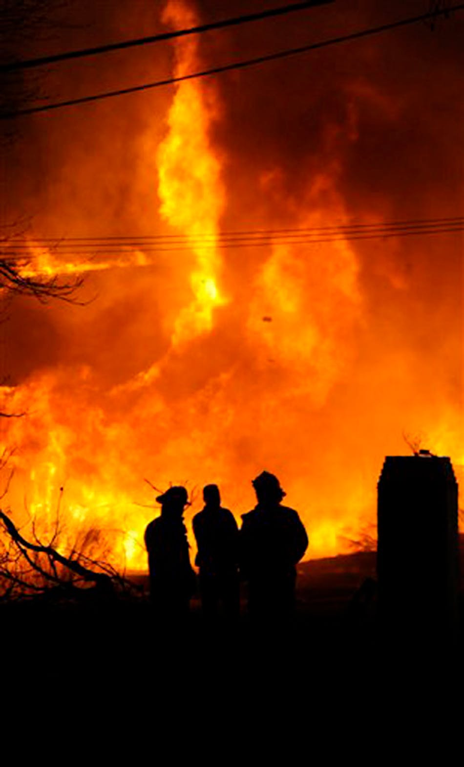 Firefighters monitor a fire at the Whispering Pines Motel in Tasley, Va. on Tuesday, March 12, 2013. Investigators believe the fire to be the work of an arsonist in Accomack County who has set more that 65 fires since November. This motel is the largest fire set so far. Parts of the motel date to the 1930s. A $25,000 reward is being offered for information leading to an arrest and conviction.
