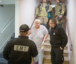 Fire and EMS crews assist residents from the building. Fire and EMS crews assist residents from the building.