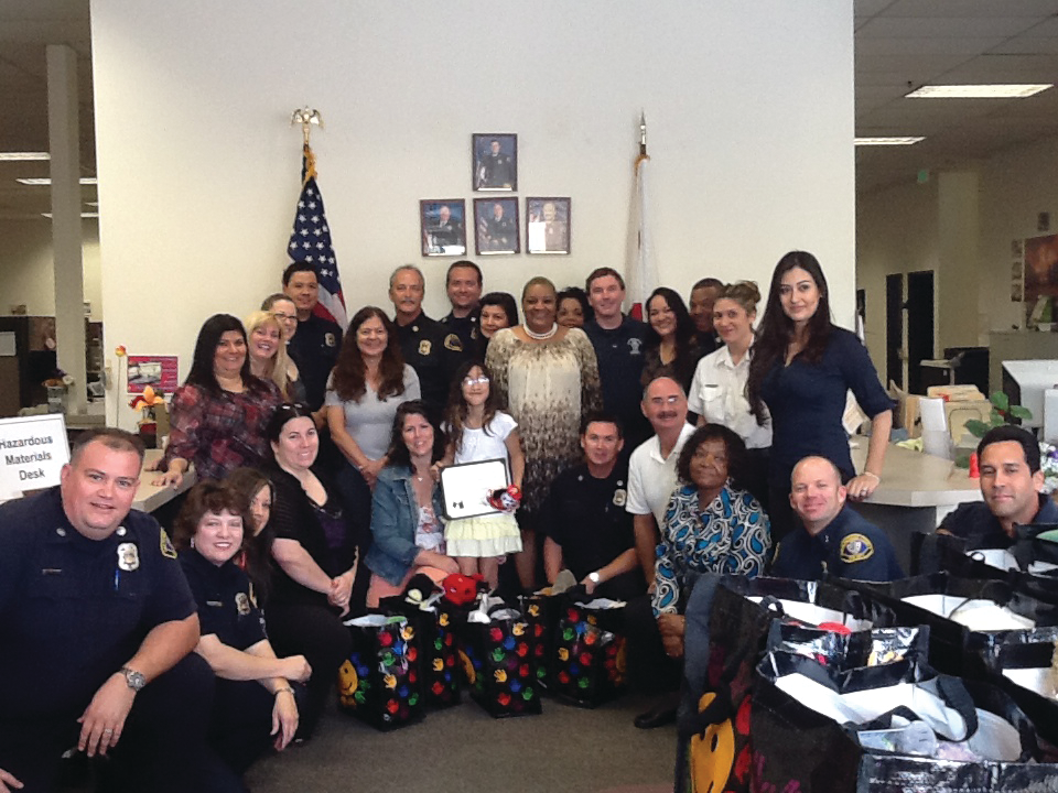 Jessica and her mom pose with the staff from the San Bernardino County&rsquo;s Office of the Fire Marshal