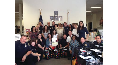 Jessica and her mom pose with the staff from the San Bernardino County&rsquo;s Office of the Fire Marshal