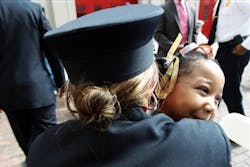 Rosalyn Weeks, 7, gets a huge hug from firefighter/paramedic Natalie Thomas following a ceremony in which Weeks was recognized by the Memphis Fire Department Tuesday, April 16, 2013, for her actions that saved her dad&apos;s life when he collapsed after his heart stopped beating due to congestive heart failure in September 2012. Thomas was one of the first responders from Engine 29 that made the scene after Weeks&apos; quick thinking.