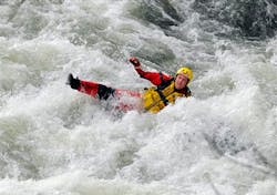 A Bowling Green, Ky., firefighter careens through the rapids of the Barren River, Monday, April 1, 2013 after trying to assist in the rescue of two teenage fishermen that were stranded in the rapids after their boat overturned. The fishermen were rescued after two hours and the firefighter was transported to the Medical Center with unknown injuries.