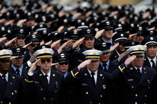 Scores of firefighters from as far away as Montreal salute their fallen brother.