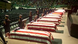 An honor guard stands by at the caskets of the fallen at the memorial service in Waco, Texas.