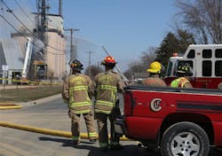 Shakopee firefighters watch as crews water down silos one and four after an explosion at an energy plant, Thursday, April 25, 2013 in Shakopee, Minn.