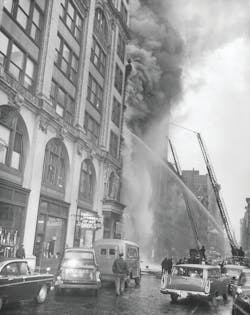 NEW YORK CITY: MARCH 19, 1958 – FDNY units battle a five-alarm fire at 623 Broadway in Manhattan. A textile oven exploded and set fire to the third floor of the five-story factory. Twenty-five people were killed and numerous others were saved by firemen using Ladder 20’s aerial ladder. The fire was reported at 3:55 P.M. NEW YORK CITY: MARCH 19, 1958 – FDNY units battle a five-alarm fire at 623 Broadway in Manhattan. A textile oven exploded and set fire to the third floor of the five-story factory. Twenty-five people were killed and numerous others were saved by firemen using Ladder 20’s aerial ladder. The fire was reported at 3:55 P.M.