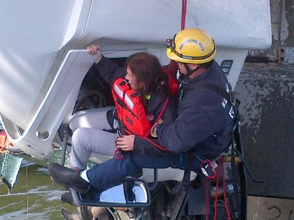 A Newport News firefighter hoists the driver to safety.