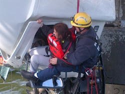 A Newport News firefighter hoists the driver to safety. A Newport News firefighter hoists the driver to safety.