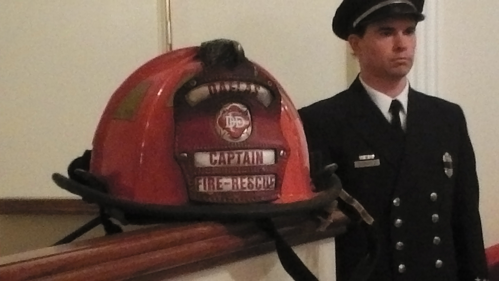 One fire service tradition is performing casket watch. Here, a Dallas firefighter stands guard for Capt. Kenny Harris.
