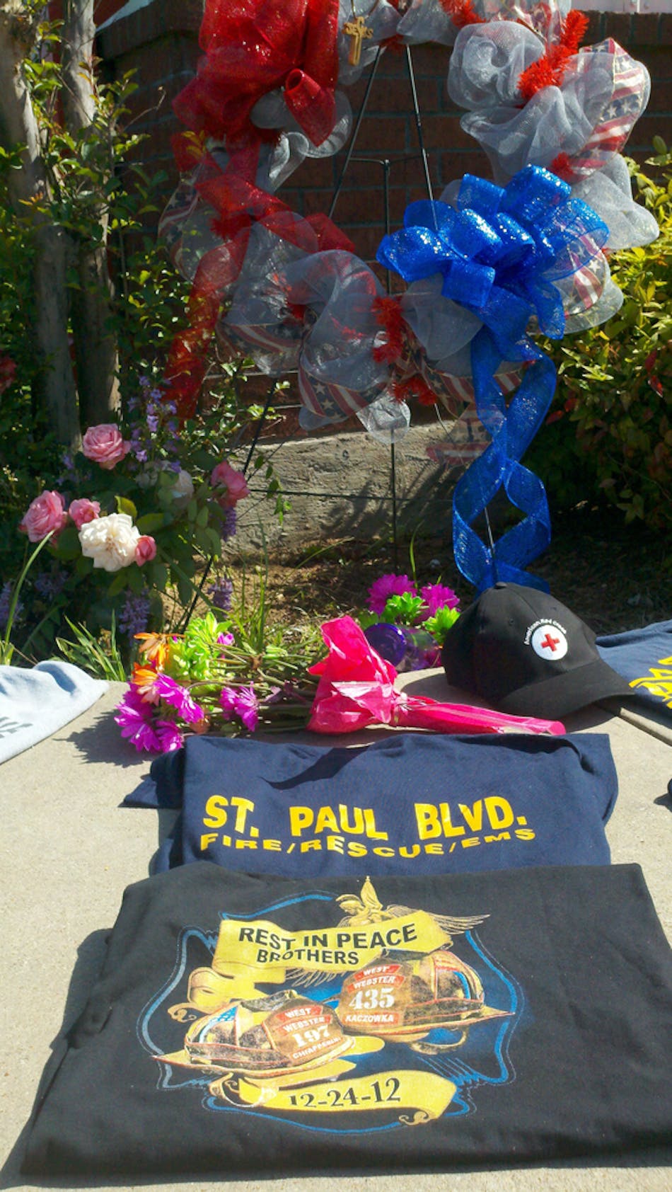 A shirt from West Webster, N.Y. Fire Department sits at a memorial outside West firehouse.